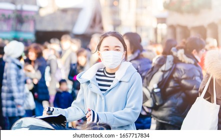 Coronavirus Covid19 Virus And Pm2.5 Concept.Japanese Mother With Kids Wearing Mask For Protect Pm2.5 And Covid-19 Virus Outdoor At Tokyo.Social Distancing Coronavirus And Pandemic Virus Symptoms.