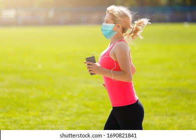 Coronavirus. COVID-19. Woman doing sport, in her garden, during quarantine with mask protection. Stay at home activities. Prevent infection from the pandemia. Social distancing. Confinement. - Powered by Shutterstock