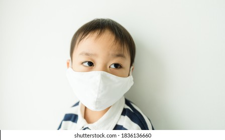 Coronavirus Covid-19.Healthcare Medical.Little Asian Boy Wearing Face Mask At Home.Toddler Stubborn Child.Punish Child At Home.Covid-19 Coronavirus.Stay Home.Lonely Kid, Sick And Illness.Mental Health