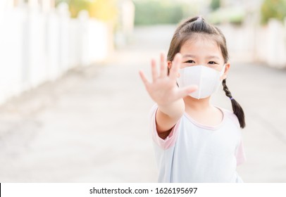 Coronavirus Covid-19.Stay at home Stay safe concept.Little chinese girl wearing mask for protect.show stop hands gesture for stop corona virus outbreak.Coronavirus.monkeypox virus.kid child girl stop. - Shutterstock ID 1626195697