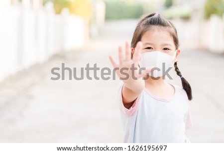 Coronavirus Covid-19.Stay at home Stay safe concept.Little chinese girl wearing mask for protect.show stop hands gesture for stop corona virus outbreak.Coronavirus.monkeypox virus.kid child girl stop.