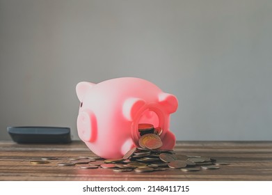 Coronavirus. Depressed And Concerned Businessman Due To The Impact On Retail Enterprises, Which Has Resulted In Job Losses And Financial Hardship Spend Less Money Quarantine Isolated Piggy Bank.