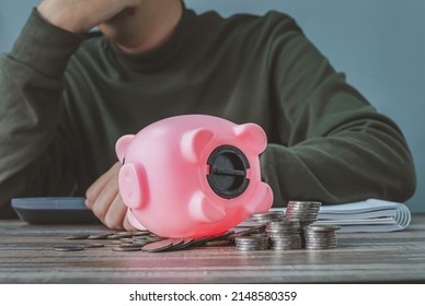 Coronavirus. Depressed And Concerned Businessman Due To The Impact On Retail Enterprises, Which Has Resulted In Job Losses And Financial Hardship Spend Less Money Quarantine Isolated Piggy Bank.