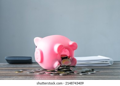 Coronavirus. Depressed And Concerned Businessman Due To The Impact On Retail Enterprises, Which Has Resulted In Job Losses And Financial Hardship Spend Less Money Quarantine Isolated Piggy Bank.