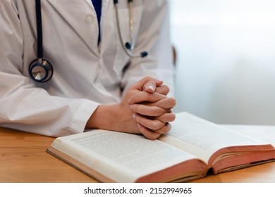 Coronavirus disease Covid-19. Female doctor or nurse prays with hands together in a gesture of hope for God, hope, faith, belief, salvation. Patients infected with the plague.