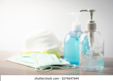 Coronavirus disease (COVID-19) prevention set, medical surgical masks and hand sanitizer gel for hand hygiene, health care concept. - Shutterstock ID 1674647644