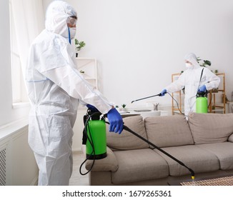 Coronavirus disinfection. People in hazmats making disinfection in flat, copy space, hot steam disinfection - Shutterstock ID 1679265361