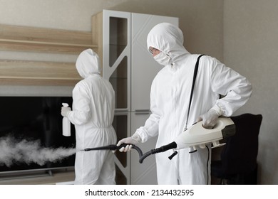 Coronavirus disinfection. People in hazmats making disinfection in flat, copy space, hot steam disinfection - Powered by Shutterstock