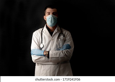 Coronavirus. Doctors And Nurses Working In The Hospitals And Fighting The Coronavirus. Doctors Are Heroes. Doctor Isolated With Mask Looking For A Cure To Corona Virus Fight. Black Background.