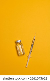 Coronavirus, flu or measles vaccine vial with syringe on yellow background, horizontal banner with copy space. Family immunization concept. Minimal style