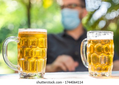 Coronavirus. Friends Making A Beer, Talking And Laughing In A Garden And Wearing Face Mask Protective. Social Distancing. Drink Safety. 