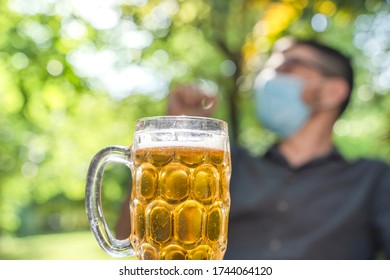 Coronavirus. Friends Making A Beer, Talking And Laughing In A Garden And Wearing Face Mask Protective. Social Distancing. Drink Safety. 