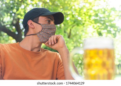 Coronavirus. Friends Making A Beer, Talking And Laughing In A Garden And Wearing Face Mask Protective. Social Distancing. Drink Safety. 