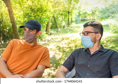 Coronavirus. Friends Making A Beer, Talking And Laughing In A Garden And Wearing Face Mask Protective. Social Distancing. Drink Safety. 