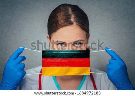 Coronavirus in Germany, Deutschland Female Doctor Portrait hold protect Face surgical medical mask with Germany National Flag. Illness, Virus Covid-19 in Germany, concept photo