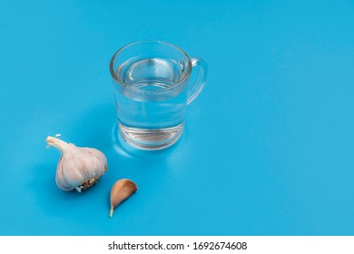 Coronavirus Or Health Care Myths: Drinking Hot Water And Eating Garlic, Blue Background