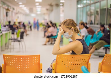 Coronavirus In The Hospital Covid 19. Woman In A Medical Mask Patients In Doctors Waiting Room