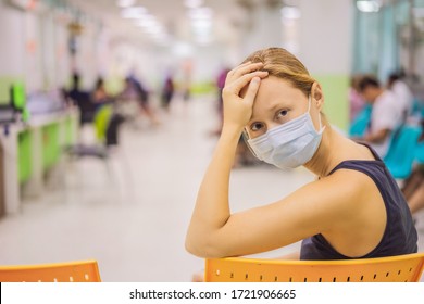 Coronavirus In The Hospital Covid 19. Woman In A Medical Mask Patients In Doctors Waiting Room