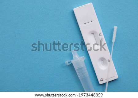 Coronavirus lateral flow home testing kit against a blue background