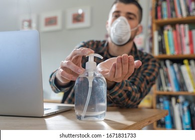 Coronavirus. Man working from home wearing protective mask. quarantine for coronavirus wearing protective mask. Working from home. Cleaning her hands with sanitizer gel.  Thermometer fever inspection. - Powered by Shutterstock