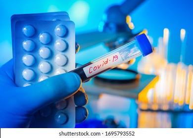 Coronavirus Medication Pills and test tube with the inscription covid. Sticker covid 19 on a blood sample. Concept - pills to facilitate pandemic pandemic. Antidote. Antidote. Vaccine.