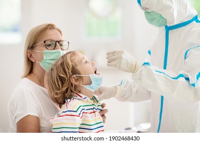 Coronavirus nasal swab test for kids. Doctor taking saliva sample for covid-19 diagnostics of child. Little boy patient in hospital. Protective hazmat suit for nurse and medical staff. Virus outbreak. - Powered by Shutterstock