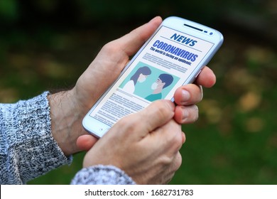 Coronavirus News. Man with smartphone in his hands reading about covid-19 virus. Online news in the screen of phone. Breaking News.