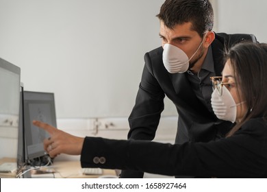 Coronavirus Office Workers With Mask For Corona Virus. Business Workers Wear Masks To Protect And Take Care Of Their Health. Office Working With Computer. Working From Home. 