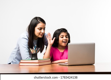 Coronavirus Outbreak and education concept - Lockdown and school closures. Indian Mother helping daughter studying online classes at home. COVID-19 pandemic forces children and teachers e-learning