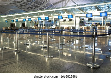 Coronavirus outbreak, empty check-in desks at the airport terminal due to pandemic of coronavirus and airlines suspended flights. - Shutterstock ID 1668825886
