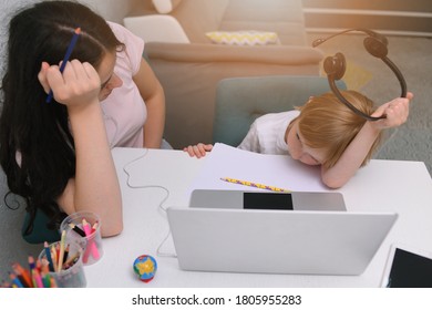 Coronavirus Outbreak. Lockdown and school closures. Mother helping her son studying online classes at home. COVID-19 pandemic forces children and teachers online learning.