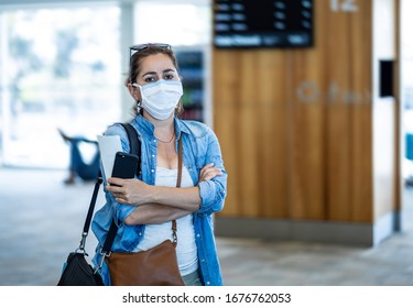 Coronavirus Outbreak Travel Restrictions. Travelers With Face Mask At International Airport Affected By Flight Cancellation And Travel Ban. COVID-19 Pandemic And Countries Shutdowns.