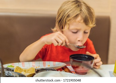 Coronavirus Is Over. Quarantine Weakened. Take Off The Mask. Now You Can Go To Public Places. Little Boy Eating Japanese Soup In The Japanese Restaurant