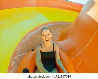 Coronavirus Is Over. Quarantine Weakened. Take Off The Mask. Now You Can Go To Public Places. Happy Woman Have Fun On Water Slike On Outdoor Swimming Pool