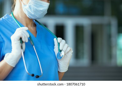 Coronavirus Pandemic. Closeup On Physician Woman In Uniform With Stethoscope And Medical Mask Outside Near Clinic.