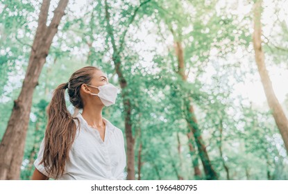 Coronavirus Pandemic End Asian Girl Looking Up In Hope Wearing Face Mask Walking In Forest. PPE Lifestyle Breathing Clean Air.