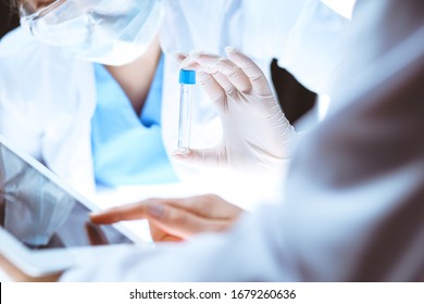 Coronavirus pandemic. Professional female scientist in protective eyeglasses researching tube with reagents in laboratory. Concepts of medicine and virus protection - Shutterstock ID 1679260636