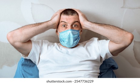 Coronavirus Panic And Anxiety. Scared Man Holding Head In Hands Looking At Camera In Fear Sitting In Bed At Home - Powered by Shutterstock