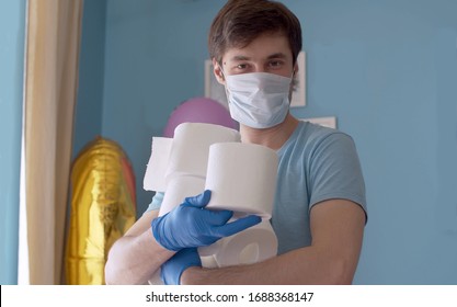 Coronavirus Panic Buying Humor. Funny Man Holding Many Rolls Of Toilet Paper, He Bought In Connection With The Epidemic. Covid-19 Pandemic, Quarantine