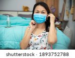 Coronavirus patient coughing and wearing a medical mask. Asian woman washes and clean hands with alcohol gel To protect from 2019-nco virus and bacteria at home.Covid-19 Virus Protection concept.