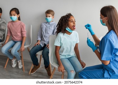 Coronavirus PCR Test. Nurse Testing Multicultural Children Group For Covid-19 Antigen Indoors. African American Girl Getting Tested For Covid Virus. Medical Diagnostic Concept