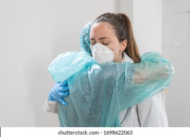 Coronavirus. Portrait Of Doctors And Nurses Hugging At Hospital And Fighting The Coronavirus. Doctors Are Heroes. Wearing Protective Suits And Masks. Great Team. Fellowship.