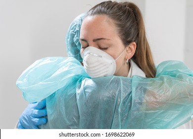 Coronavirus. Portrait Of Doctors And Nurses Hugging At Hospital And Fighting The Coronavirus. Doctors Are Heroes. Wearing Protective Suits And Masks. Great Team. Fellowship.