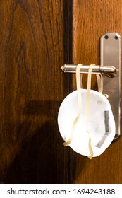 Coronavirus Prevention Mask Hanging On The Bathroom Door.