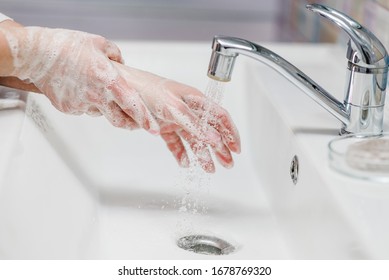 Coronavirus prevention. Wash hands with antibacterial soap and warm running water rubbing nails and fingers in sink. Washing hands. Epidemic Covid-19. Prevention of flu disease. - Shutterstock ID 1678769320