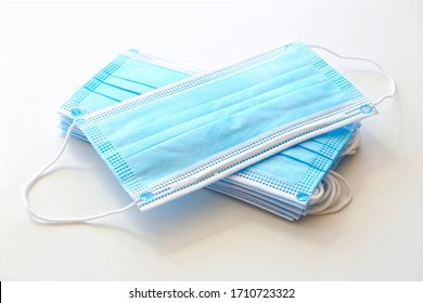 Coronavirus protection. Blue antiviral medical face masks. Surgical protective masks with ear loops on white background.                   