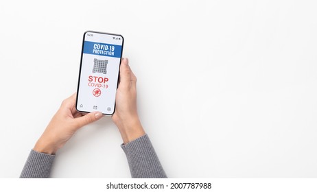 Coronavirus Protection, Stop Covid-19. Overhead above top view of female holding cellphone with qr code in hand, isolated on white studio background, free copy space, banner, panorama - Powered by Shutterstock