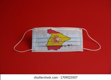 Coronavirus Protective Mask. Medical Mask With Spanish Flag Together With Map. Red Background. Face Mask Protection Against Pollution, Virus, Flu. Healthcare And Surgery Concept.