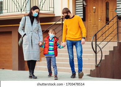 Coronavirus quarantine. Family going for a walk. Parents and kid wearing a surgical mask. Air pollution concept. Young family wearing protection face mask outdoors. Prevention coronavirus. - Powered by Shutterstock