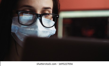 Coronavirus Quarantine. Woman At The Office With Mask For Corona Virus. Business Women Wear Masks To Protect And Take Care Of Their Health. Home Working With Computer. Working From Home.